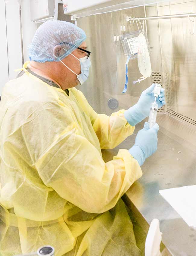 A worker prepares an infusion 